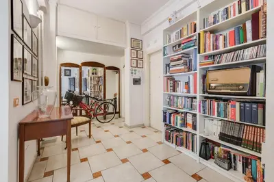 a room with book shelves filled with books at Casa Marino Roma in Rome