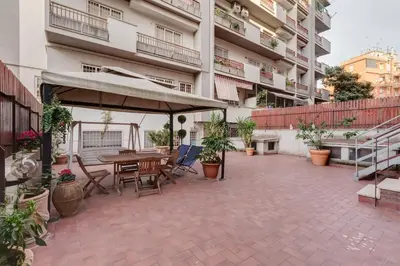 an outdoor patio with a table and umbrella at Casa Marino Roma in Rome