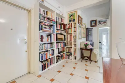 a room with large book shelves filled with books at Casa Marino Roma in Rome