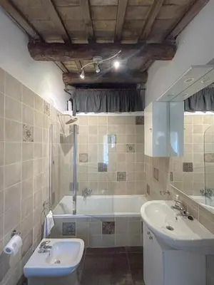 a bathroom with a tub and a toilet and a sink at Attic Castel Sant'Angelo - Pantheon in Rome