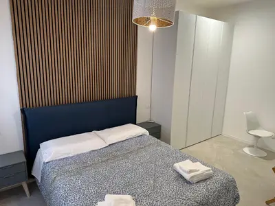 a bedroom with a bed with two towels on it at Star Suite Rome in Rome