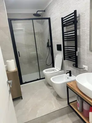 a bathroom with a shower and a toilet and a sink at Star Suite Rome in Rome