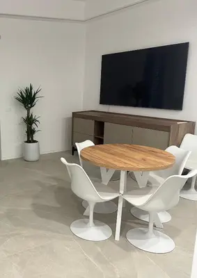 a dining room with a table and white chairs at Star Suite Rome in Rome