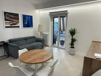 a living room with a table and a couch at Star Suite Rome in Rome