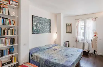 a bedroom with a bed and a book shelf at Dreamy Loft by the Opera Theater in Rome