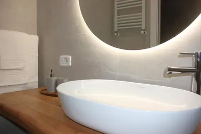 a bathroom with a white sink and a mirror at Domus San Pietro - Elegant stay in Vatican in Rome