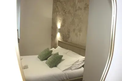 a reflection of a bed in a mirror at Domus San Pietro - Elegant stay in Vatican in Rome