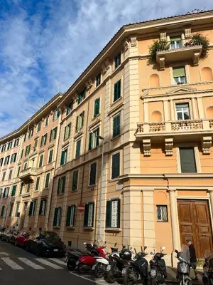 a large building with motorcycles parked in front of it at Domus San Pietro - Elegant stay in Vatican in Rome