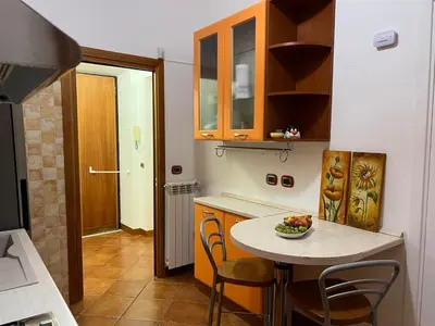 a small kitchen with a table and chairs in it at Paolina lovely apartment in Rome