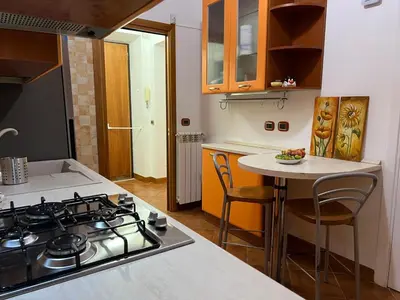 a kitchen with a stove and a small table at Paolina lovely apartment in Rome