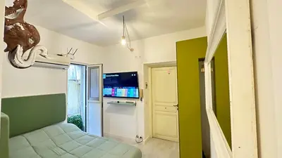 a room with a bed and a tv in a room at Tiny Elephant Mini suite in Rome in Rome
