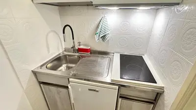 a small kitchen with a sink in a tiny house at Tiny Elephant Mini suite in Rome in Rome