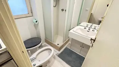 a small bathroom with a toilet and a sink at Tiny Elephant Mini suite in Rome in Rome
