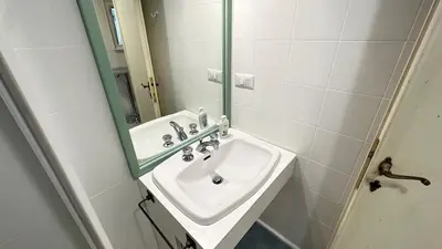 a bathroom with a sink and a mirror at Tiny Elephant Mini suite in Rome in Rome