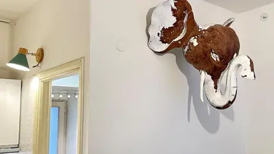 a statue of a dog on a wall next to a mirror at Tiny Elephant Mini suite in Rome in Rome
