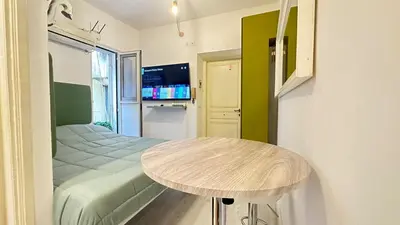 a small room with a table and a bed at Tiny Elephant Mini suite in Rome in Rome