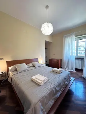 a bedroom with a large bed with two towels on it at Casa Anna Vaticano in Rome