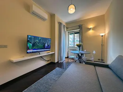 a living room with a couch and a tv and a table at Casa Anna Vaticano in Rome