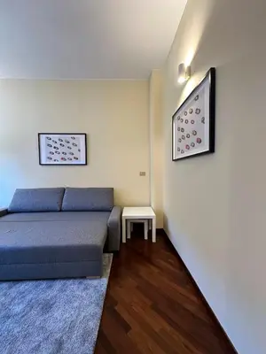 a bedroom with a blue bed and a table at Casa Anna Vaticano in Rome