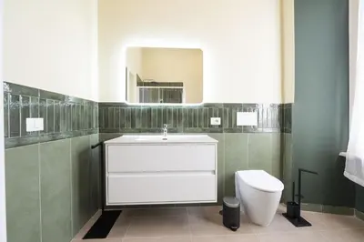 a bathroom with a white sink and a toilet at Barberini Grand Retreat with Terrace in Rome