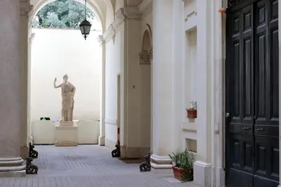 a statue of a man standing in a hallway at Barberini Grand Retreat with Terrace in Rome