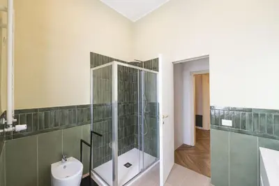 a bathroom with a glass shower and a toilet at Barberini Grand Retreat with Terrace in Rome