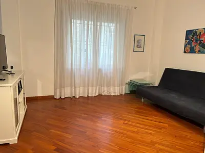 a living room with a couch and a large window at Cris House Monteverde in Rome