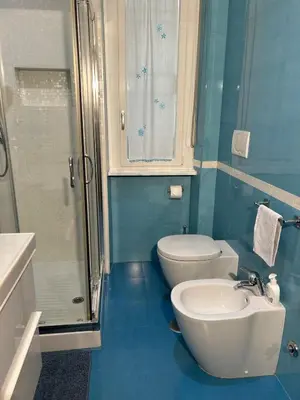 a bathroom with a toilet and a sink and a shower at Cris House Monteverde in Rome