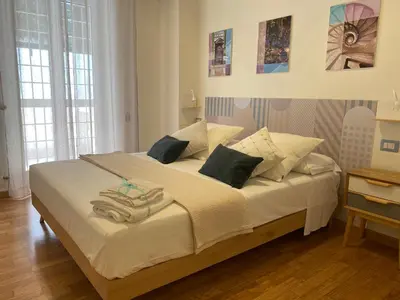 a bedroom with a large bed with towels on it at Casa Cherie in Rome