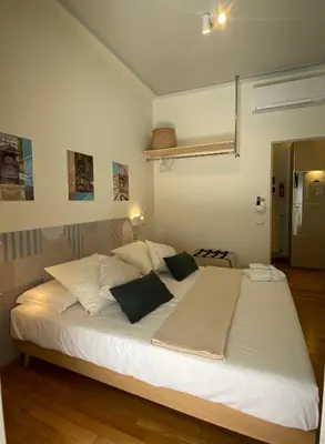 a bedroom with a large white bed with black pillows at Casa Cherie in Rome
