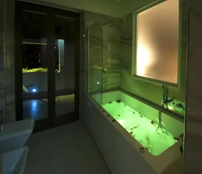 a bathroom with a tub and a sink and a mirror at Terrazza Marco Antonio Luxury Suite in Rome