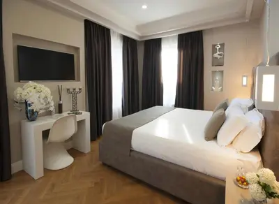 a hotel room with a bed and a television at Terrazza Marco Antonio Luxury Suite in Rome