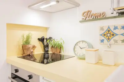 a kitchen with a counter with a clock and plants at Fienaroli in Trastevere in Rome