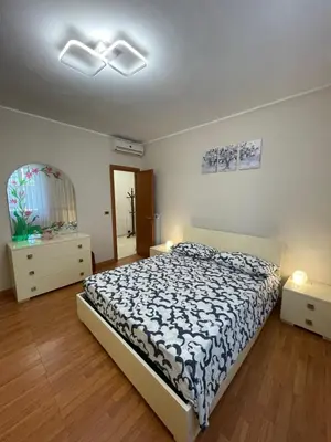 a bedroom with a bed and two night stands and a window at Eternal Lemon Home in Rome