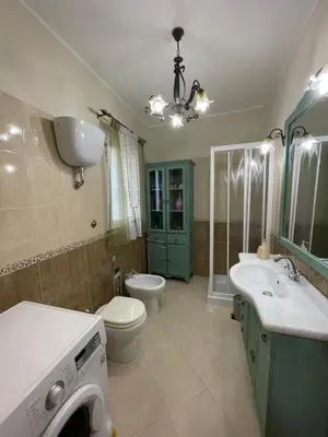 a bathroom with a toilet and a sink and a washing machine at Eternal Lemon Home in Rome