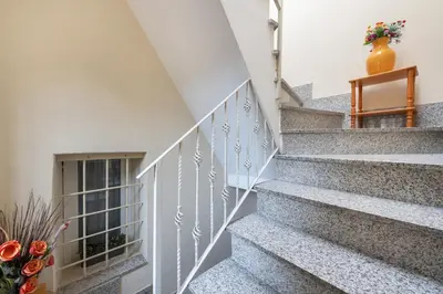 a staircase in a house with a vase of flowers at Studio basic nice&comfortable in Rome