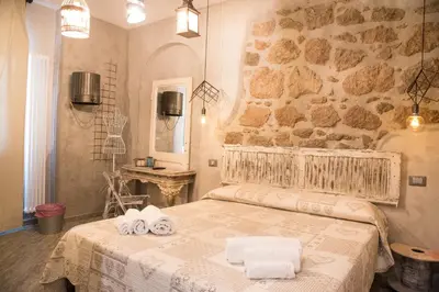 a bedroom with a bed with towels on it at Mancini Shabby House in Rome