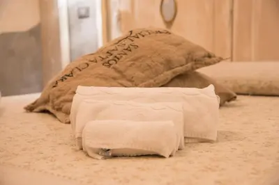 a pile of toilet paper sitting on a bed at Mancini Shabby House in Rome