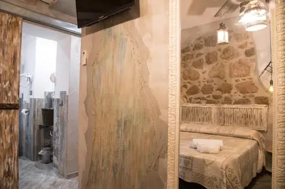 a room with a bed and a stone wall at Mancini Shabby House in Rome