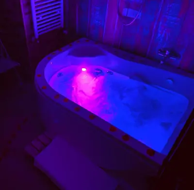 a bath tub with a pink candle in it at Mancini Shabby House in Rome