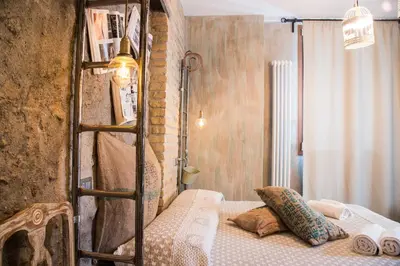 a bedroom with a bunk bed with a ladder at Mancini Shabby House in Rome