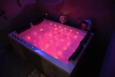 a pink hot tub with lights in a room at Mancini Shabby House in Rome