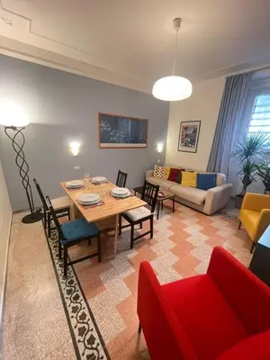a living room with a table and a couch at Celio west side apartment in Rome