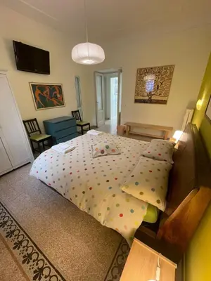 a bedroom with a large bed with polka dot sheets at Celio west side apartment in Rome