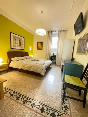 a bedroom with a bed and a chair at Celio west side apartment in Rome