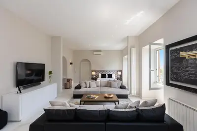 a living room with a couch and a tv at Amazing Colosseo in Rome