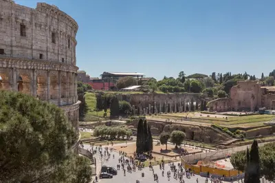 a group of people walking around the coliseum at Amazing Colosseo in Rome