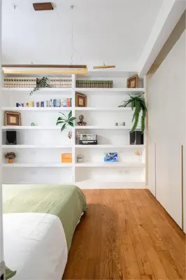 a bedroom with white walls and a bed and wooden floors at Botanical Home close Vatican in Rome
