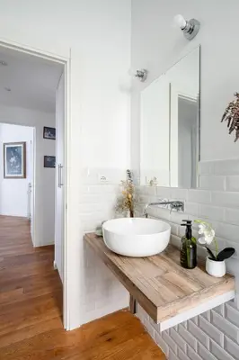 a bathroom with a large white sink on a wooden counter at Botanical Home close Vatican in Rome