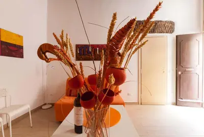 a vase with plants in it on a table at Boccanera a Trastevere Holiday Apartment in Rome